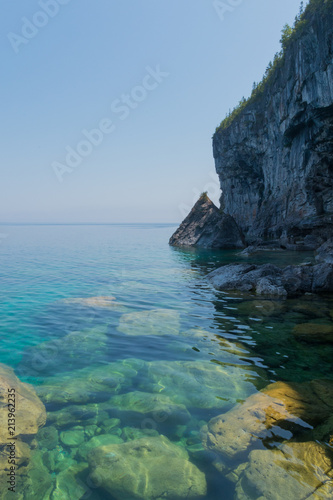 Bright clear aqua green water on Bruce Peninsula with big limestone rocks