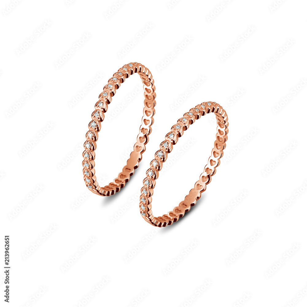A pair of luxury rose gold rings with diamonds on the white background, isolated, golden rings isolated