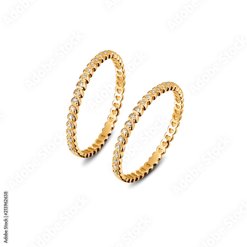 A pair of luxury yellow gold rings with diamonds on the white background, golden rings isolated