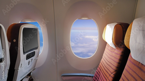 Closeup the window of the passenger plane and empty seats, concepts for industrial transportation.