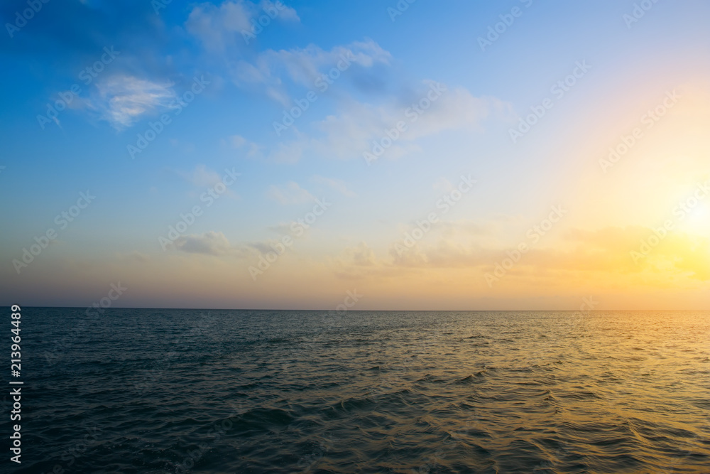 Summer sunset seascape with wide horizon of the sky and the sea