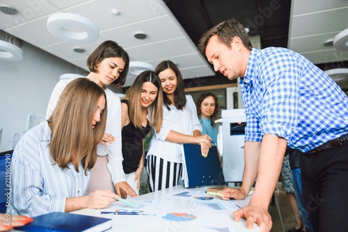 Business team in casual clothes brainstorming at the table in a modern office
