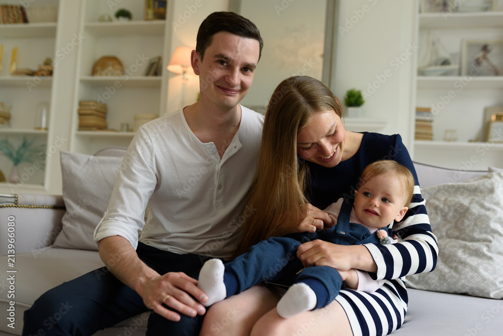 Happy parents playing with child at home Happy parents playing with child at home
