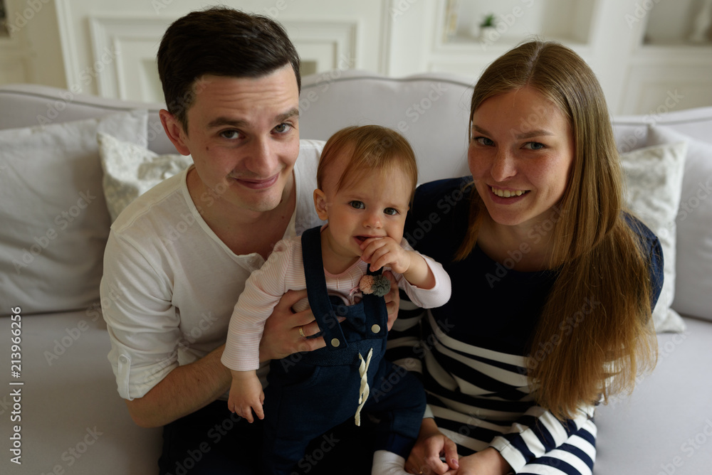 Happy parents playing with child at home Happy parents playing with child at home