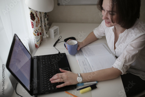 thoughtful tired woman working at computer at home