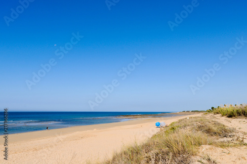 Fototapeta Naklejka Na Ścianę i Meble -  Nearly empty beach on sunny day in Zahora, Cadiz province in South Spain. Low season, economic crisis, travel destination, summer vacation concepts