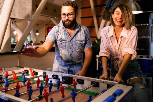 Friends play table football in the bar