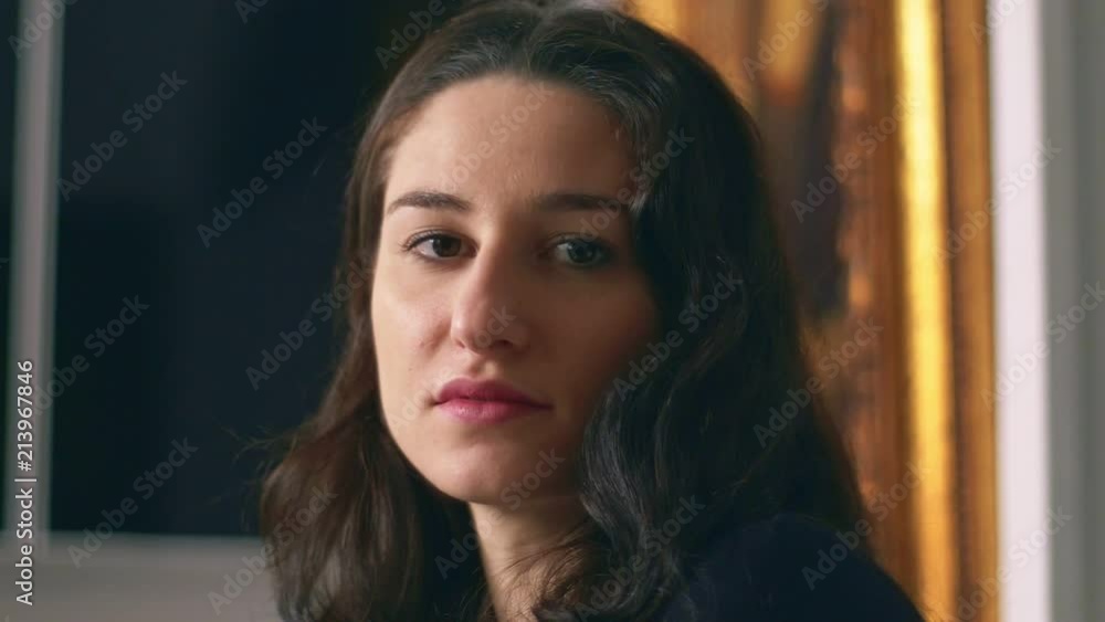 Attractive young brunette loooking and smiling- indoor