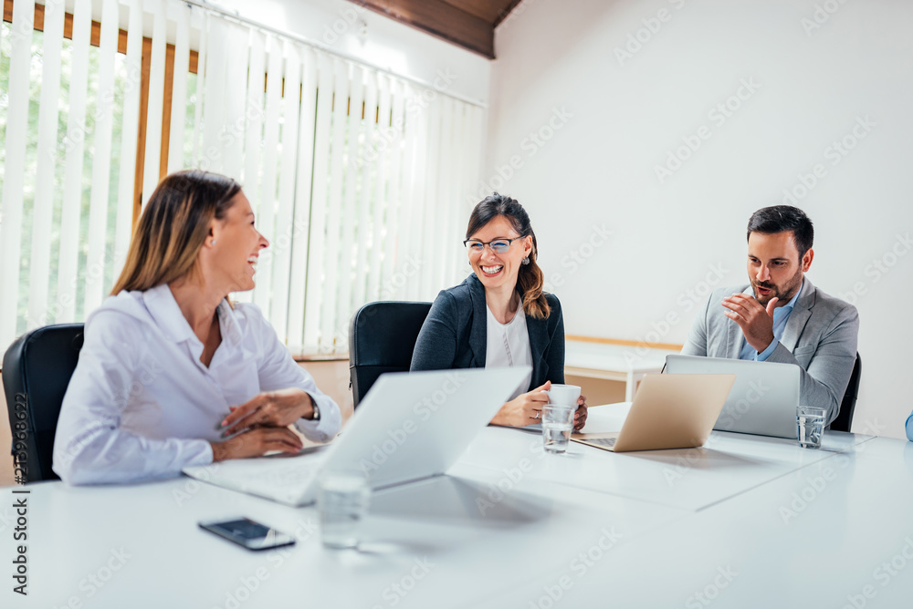 Work colleagues chatting in board room. Work colleagues chatting in board room.