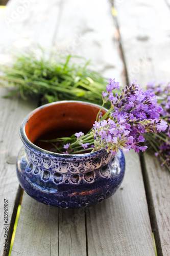 Fototapeta Naklejka Na Ścianę i Meble -  A bouquet of fresh cut lavender with tableware Gzhel