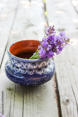 Fototapeta Naklejka Na Ścianę i Meble -  A bouquet of fresh cut lavender with tableware Gzhel