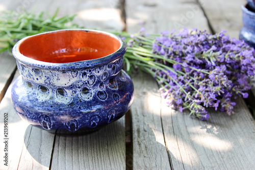 Fototapeta Naklejka Na Ścianę i Meble -  A bouquet of fresh cut lavender with tableware Gzhel