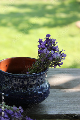 Fototapeta Naklejka Na Ścianę i Meble -  A bouquet of fresh cut lavender with tableware Gzhel