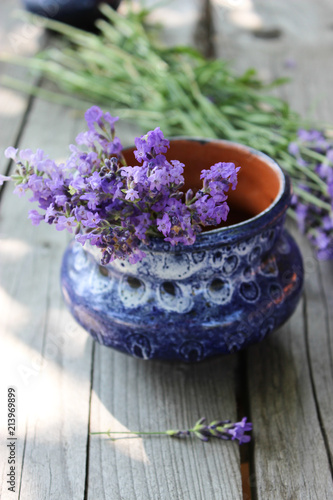 Fototapeta Naklejka Na Ścianę i Meble -  A bouquet of fresh cut lavender with tableware Gzhel