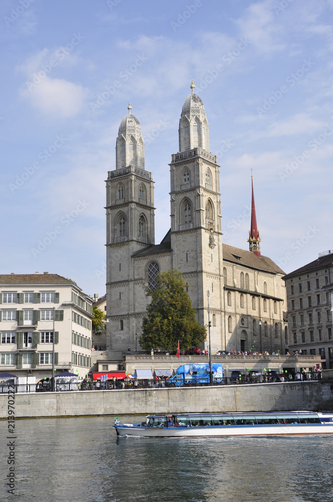 Zürich's Grossminster and a Limmat cruise-boat in front floating down to the main station in the old town