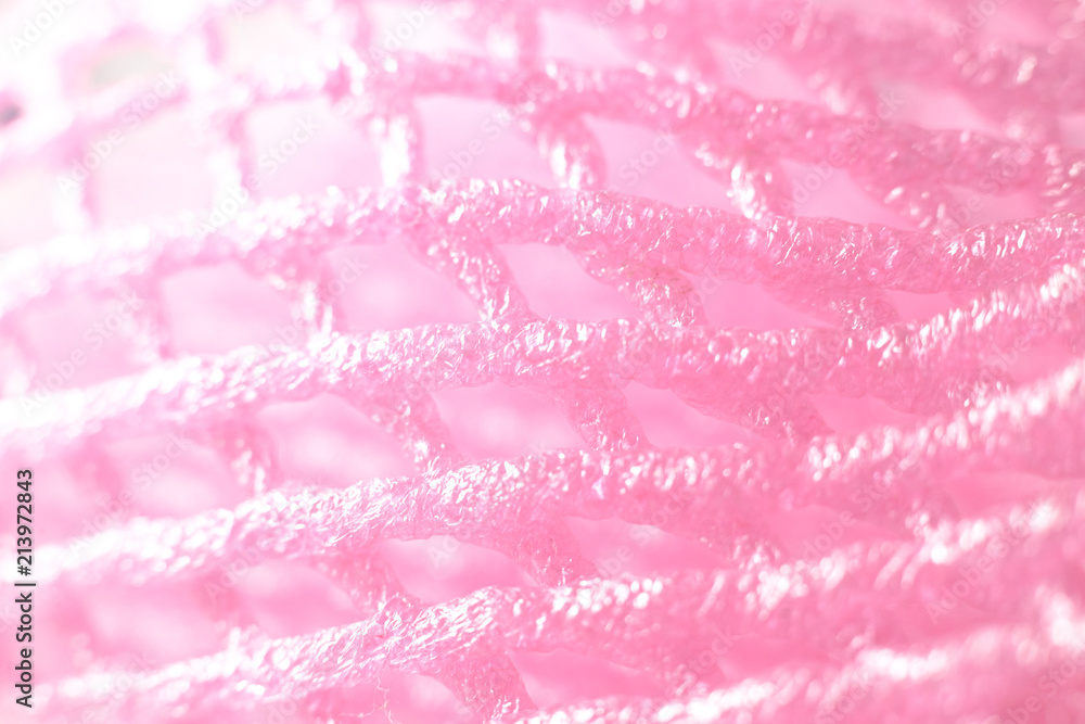 Macro closeup soft pink fruit net with light shine on