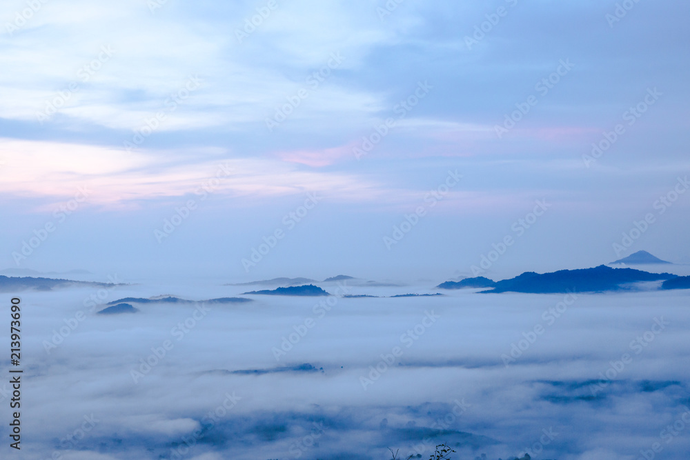 Hill view of ocean fog in dawn time with rainbow sky