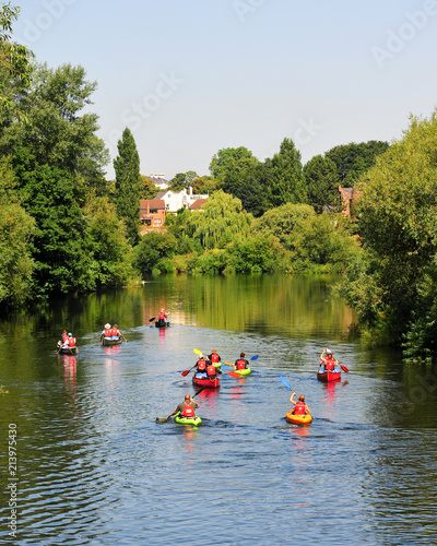 Group of people kayaking and canoeing down a river