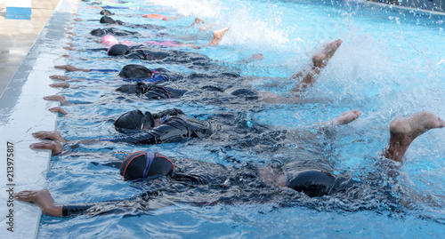 leg shot of kid at swimming pool class learning to swim