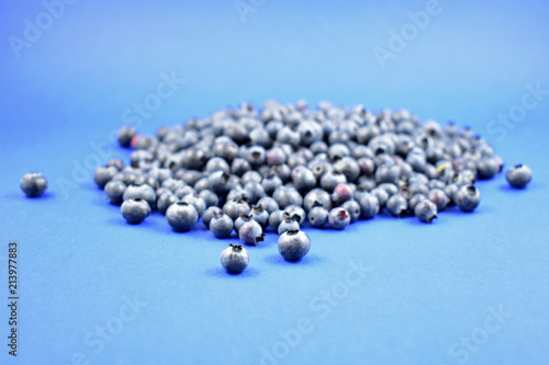 Blueberries stock images. Blueberries on a blue background. Healthy summer fruit