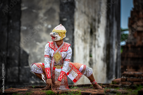 Hanuman-TossakanThai high classical dance in mask. Thai traditional dancing in a nice green, white color shiny outfit background by historical temple in Lopburi province.