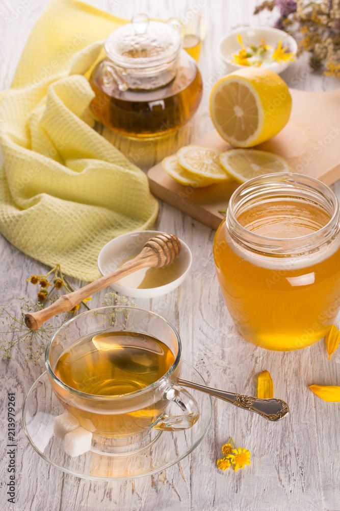 Cup of tea and honey in a glass jar Cup of tea and honey in a glass jar