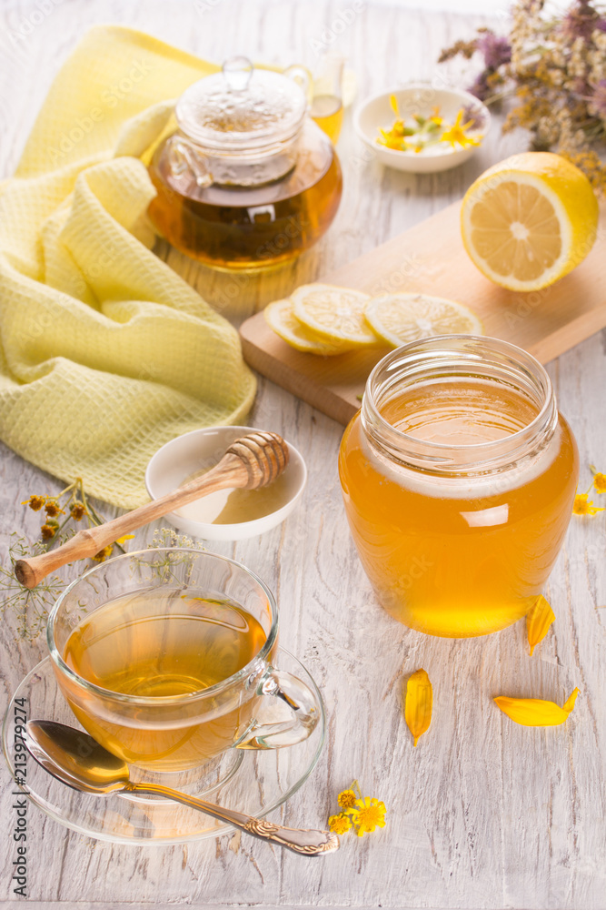 Cup of tea and honey in a glass jar Cup of tea and honey in a glass jar