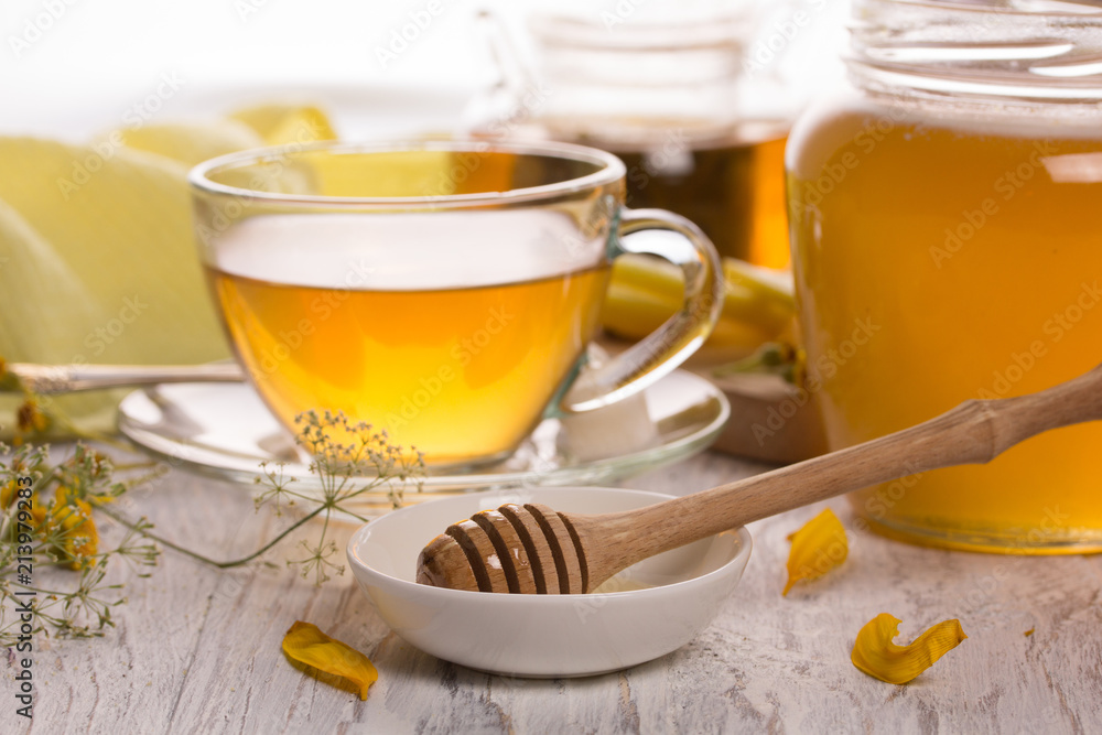Cup of tea and honey in a glass jar Cup of tea and honey in a glass jar