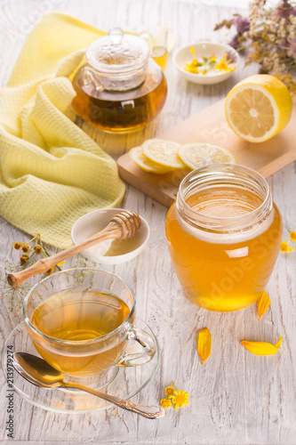 Cup of tea and honey in a glass jar