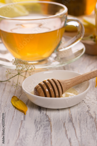 Cup of tea and honey in a glass jar