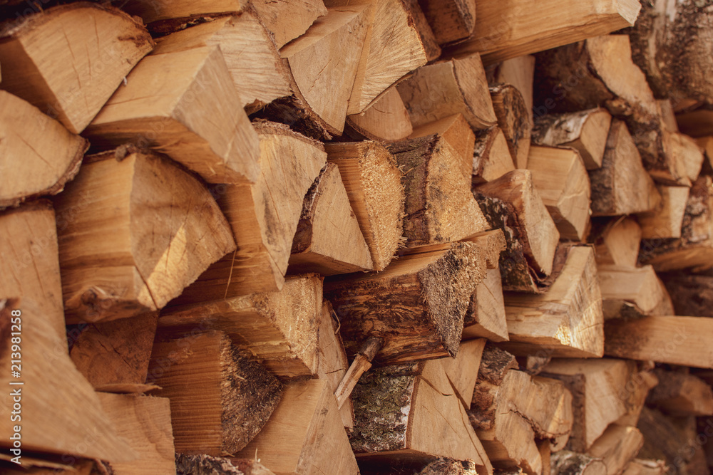 A stack of dry firewood, prepared for winter. Material for heating the house. Ecological natural fuel. Firewood texture for the background. A stack of dry firewood, prepared for winter. Material for heating the house. Ecological natural fuel. Firewood texture for the background.