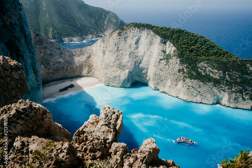 Navagio beach or Shipwreck bay with turquoise water and pebble white beach. Famous landmark location. Landscape of Zakynthos island, Greece