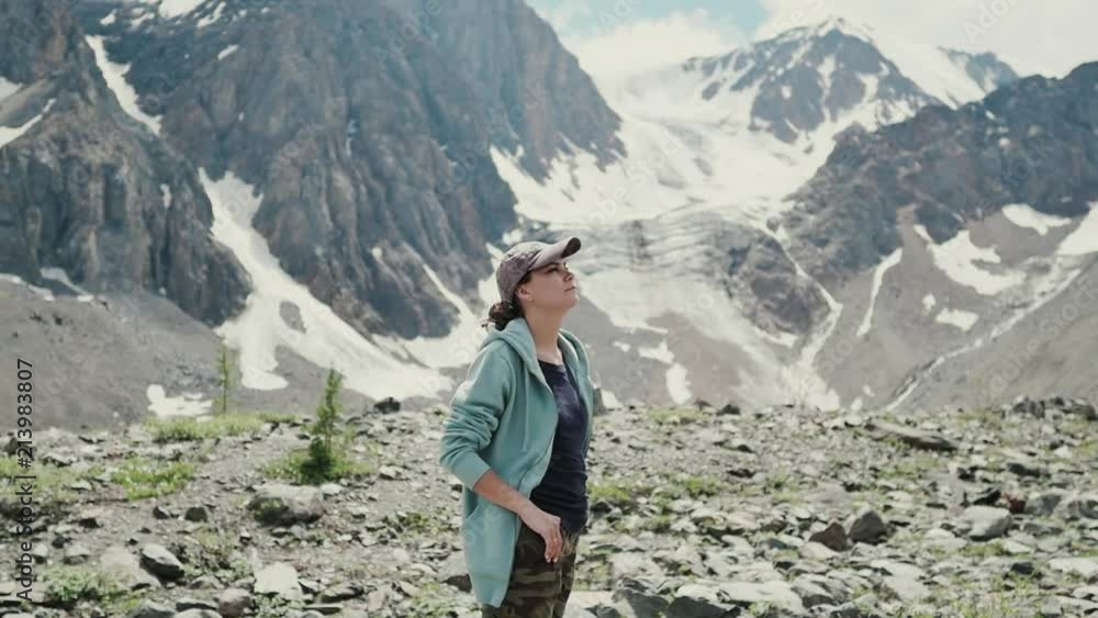 Woman on top of mountain. Girl lifting arm up celebrating scenic nature landscape enjoying vacation travel adventure Woman on top of mountain. Girl lifting arm up celebrating scenic nature landscape enjoying vacation travel adventure