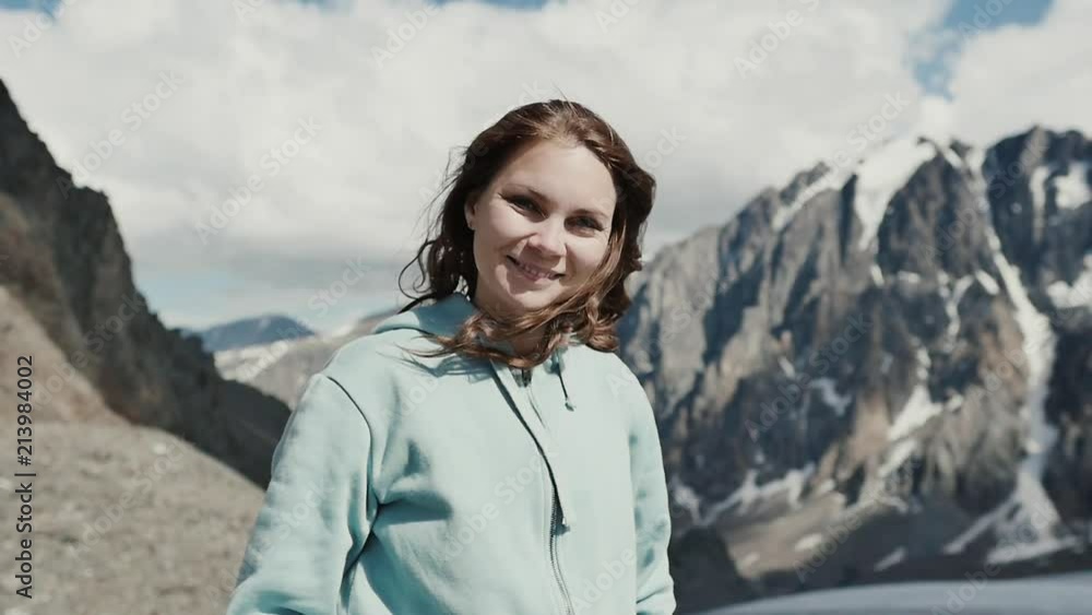 Woman on top of mountain. Girl lifting arm up celebrating scenic nature landscape enjoying vacation travel adventure Woman on top of mountain. Girl lifting arm up celebrating scenic nature landscape enjoying vacation travel adventure