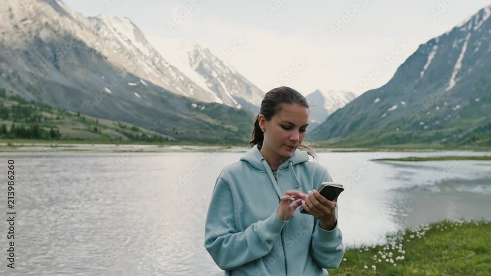Woman on top of mountain. Girl lifting arm up celebrating scenic nature landscape enjoying vacation travel adventure Woman on top of mountain. Girl lifting arm up celebrating scenic nature landscape enjoying vacation travel adventure