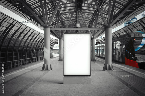 Blank white banner at metro station with arrived train on a background photo