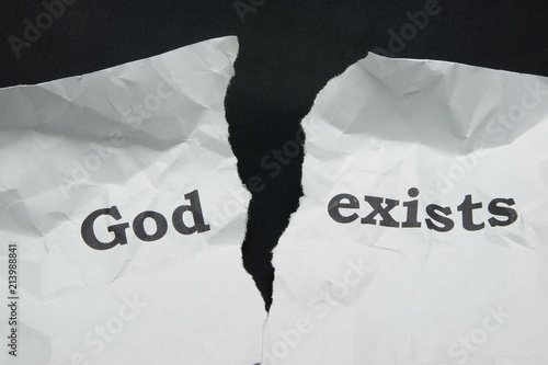 Atheism. Torn sheet of paper with the inscription.