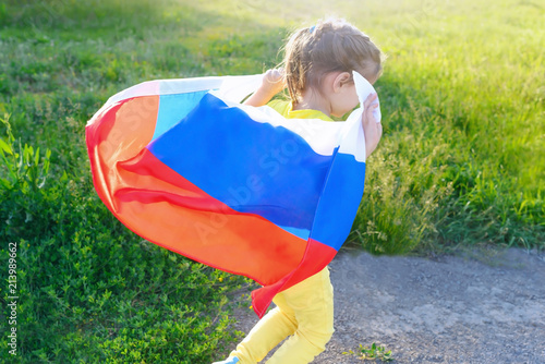 girl child holding the flag of Russia.