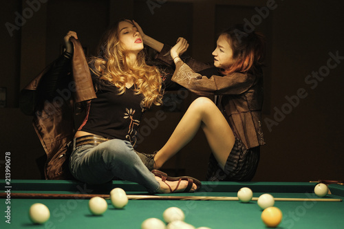 two beautiful girls in the billiard room