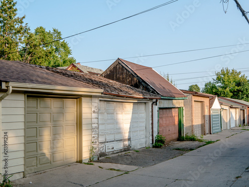 Photos Assortment of diverse garages tightly spaced on an urban laneway