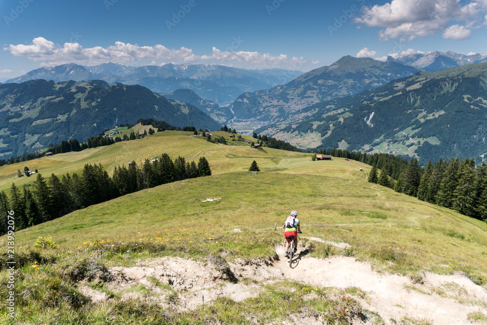 retired senior citizens mountain bike in an idyllic alpine landscape in Switzerland near Klosters