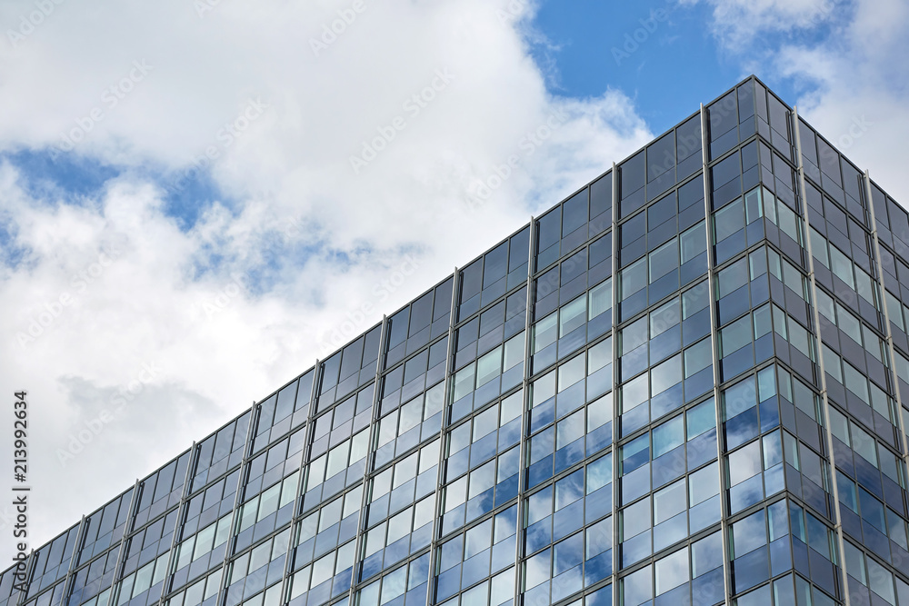 Office building reflecting the blue sky