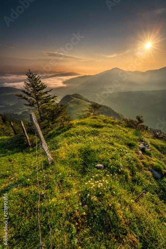 sunrise over the mountains with a view of the foggy valley