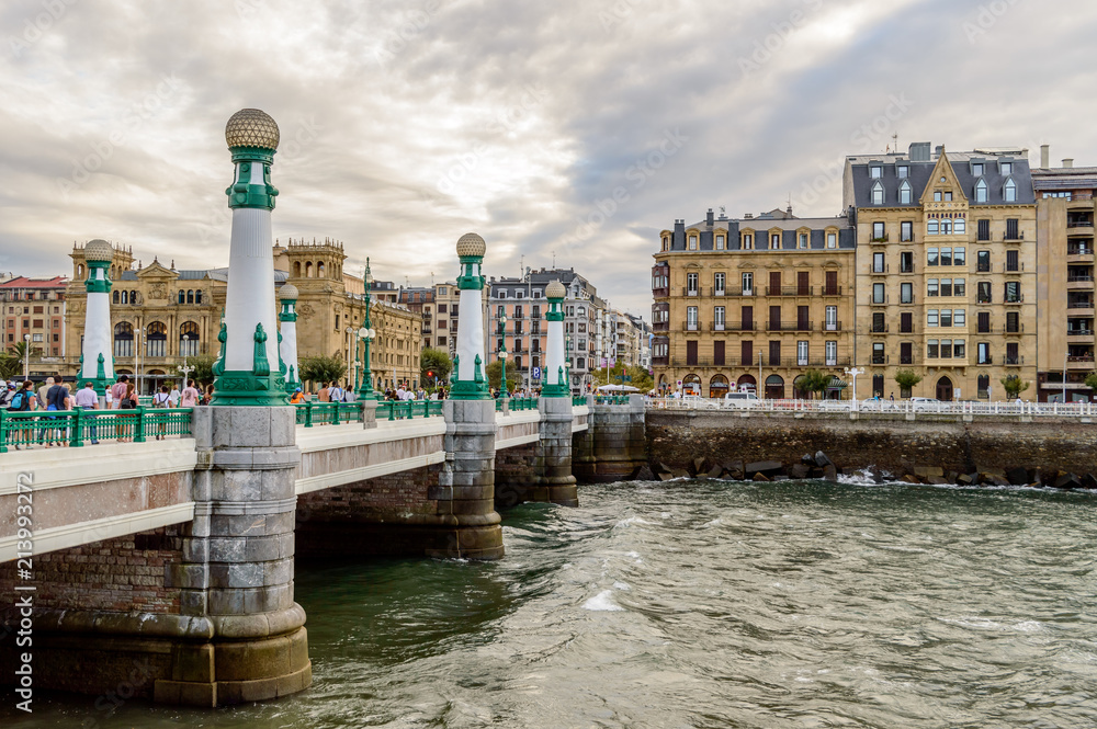 Fototapeta premium City view of San Sebastian or Donostia with a bridge and water at the front and baroque buildings at the back