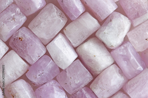 Pink purple background of natural stones. Kunzite is a natural pink stone for creating Jewelry. Natural crystals of pink and lilac stones photo