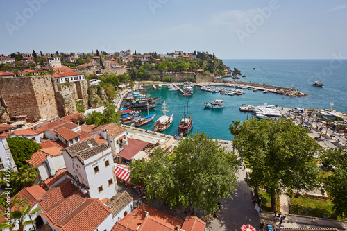 Fototapeta Naklejka Na Ścianę i Meble -  Aerial view of yacht harbor and red house roofs in Old town timelapse Antalya, Turkey.