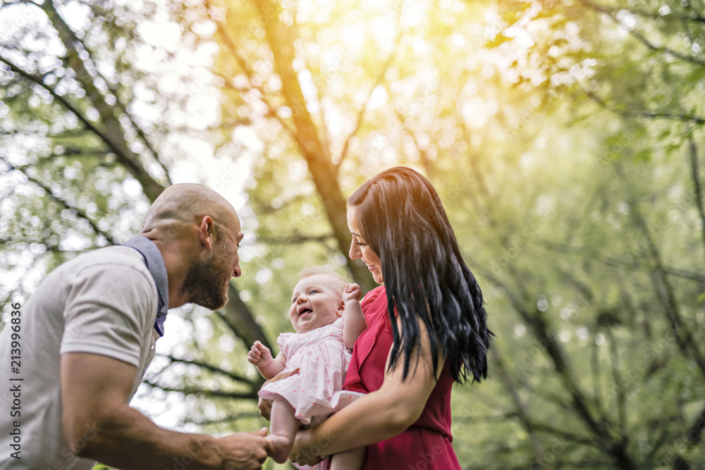 Fototapeta premium Father Mother and daughter baby in summer meadow park