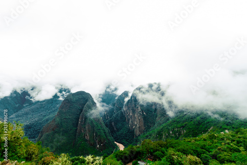 Mountain Putucusi and Urubamba river seen from the terraces of Machu Picchu photo