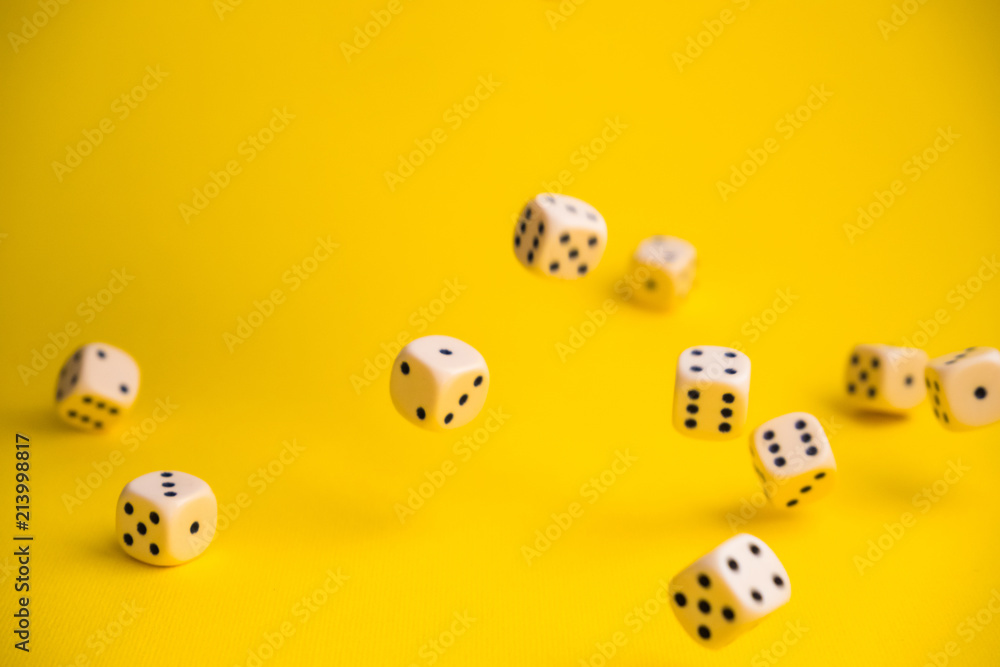 dice in the fall on a yellow background dice in the fall on a yellow background