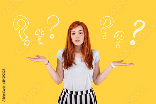 Many questions. Diligent serious student putting her hands up and thinking about her life after graduation from the university